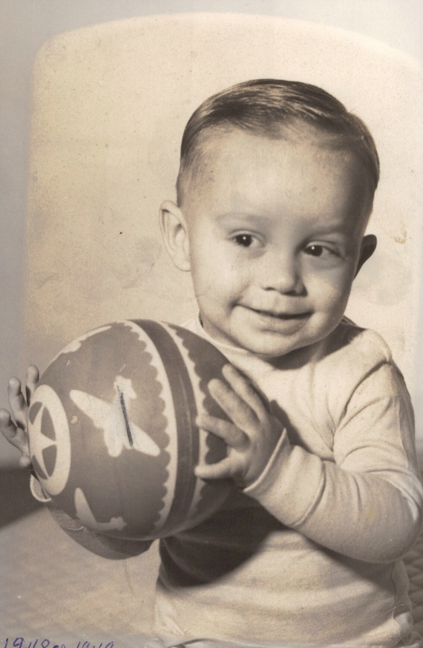 Studio portrait of a toddler holding a ball