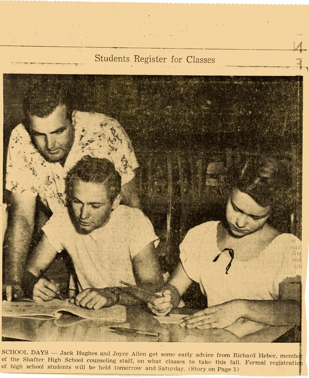 Three high school students consulting with a counselor at a registration table
