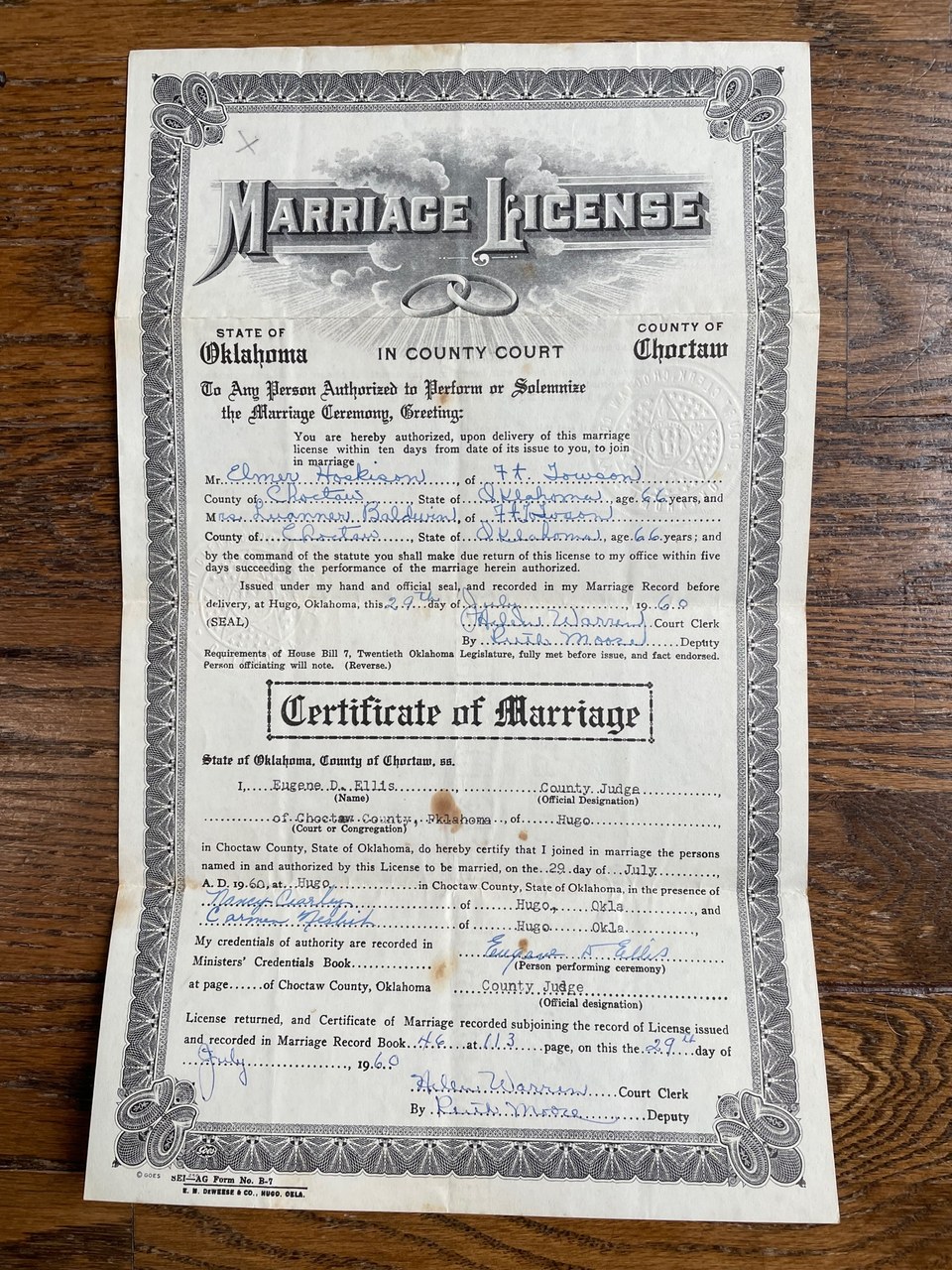 Official Oklahoma marriage license and certificate of marriage from Choctaw County, dated July 29, 1960, issued in Hugo, Oklahoma, lying flat on a wooden surface.