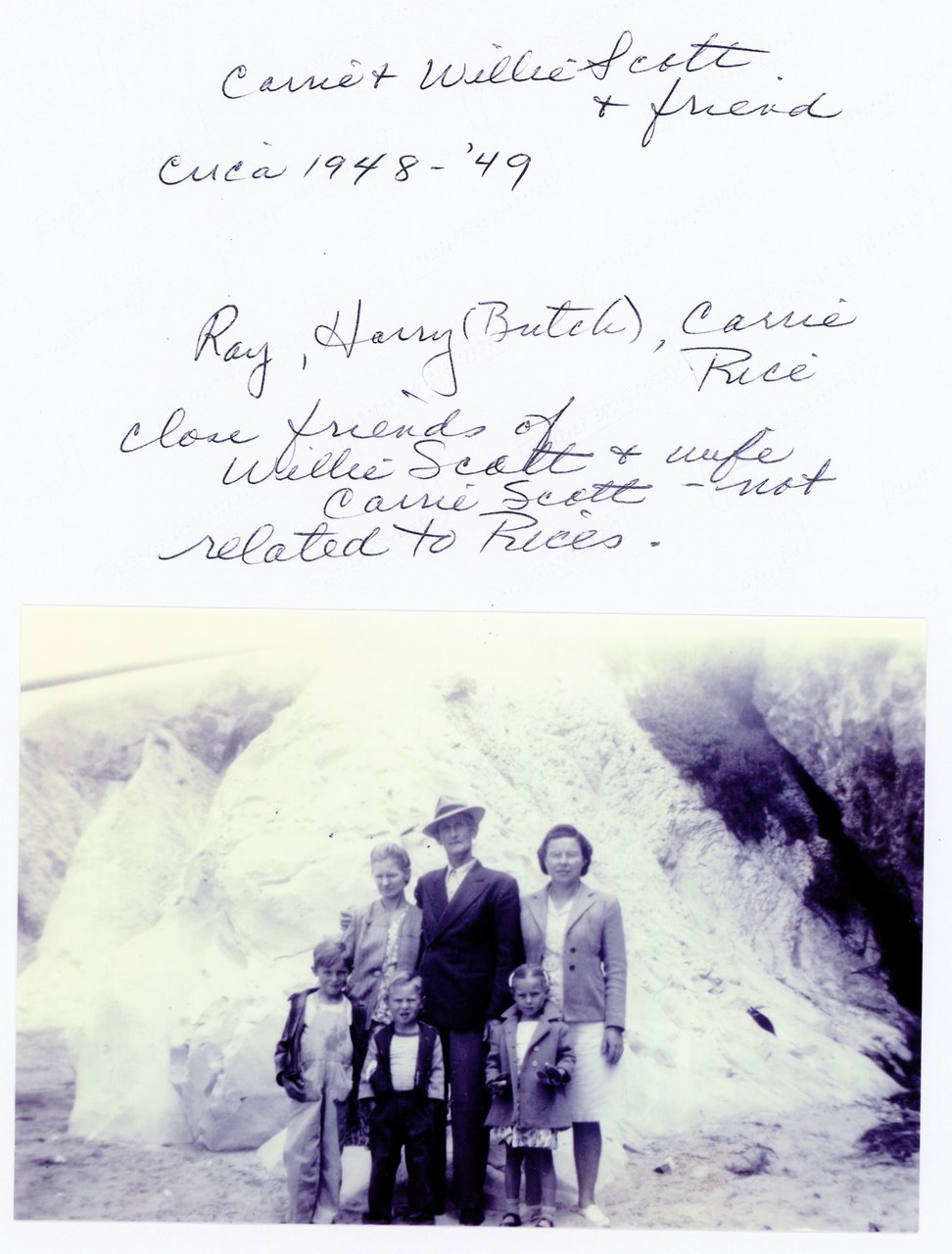 Five people standing in front of large cave entrance, black and white photo, circa 1948–49.