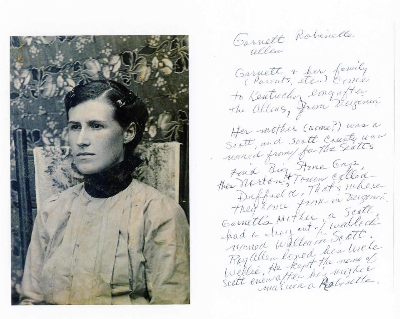Hand-colored portrait photograph of a young man in pale shirt against floral wallpaper backdrop, early 20th century.